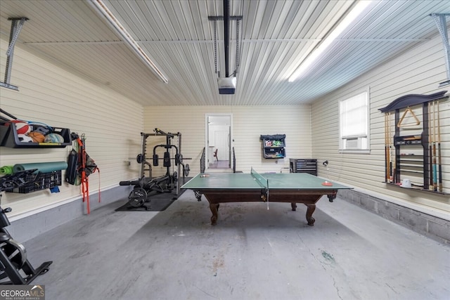 142 Poplar St SW, Calhoun, GA 30701 - recreation room featuring a garage, cooling unit, and concrete floors