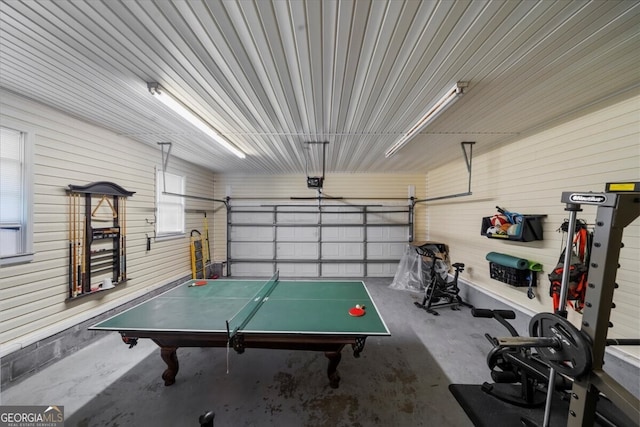142 Poplar St SW, Calhoun, GA 30701 - game room with concrete floors, wooden walls, and a garage