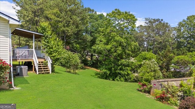 142 Poplar St SW, Calhoun, GA 30701 - view of yard featuring stairs, central air condition unit, a deck, and fence