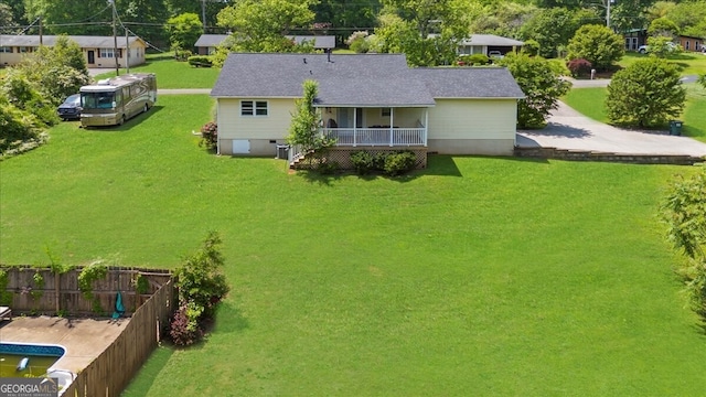 142 Poplar St SW, Calhoun, GA 30701 - back of house with a lawn, fence, cooling unit, a porch, and roof with shingles