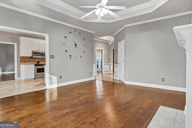 176 Fairethorne Dr, Leesburg, GA 31763 - unfurnished living room with a ceiling fan, a raised ceiling, ornamental molding, and light wood-type flooring