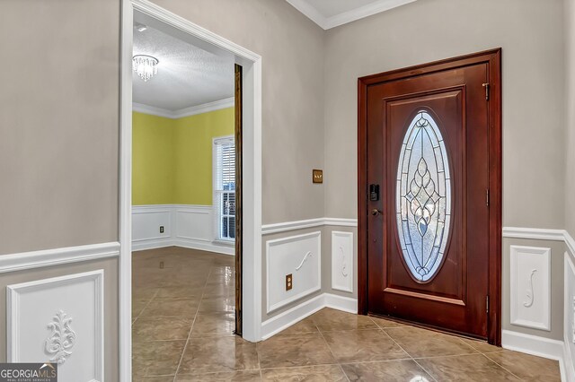 176 Fairethorne Dr, Leesburg, GA 31763 - tiled entryway with a decorative wall, wainscoting, and ornamental molding