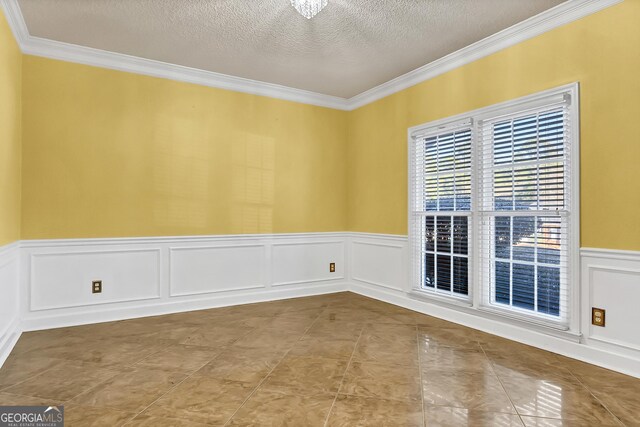 176 Fairethorne Dr, Leesburg, GA 31763 - tiled spare room featuring wainscoting, crown molding, a textured ceiling, and a decorative wall