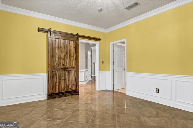 176 Fairethorne Dr, Leesburg, GA 31763 - spare room with ornamental molding, wainscoting, a barn door, and a textured ceiling