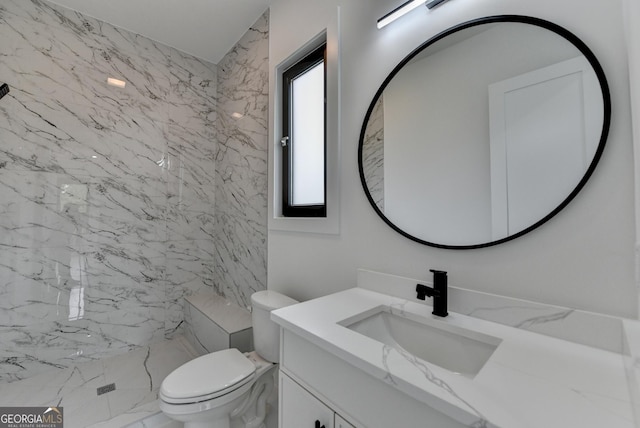 full bath featuring toilet, marble finish floor, walk in shower, and vanity
