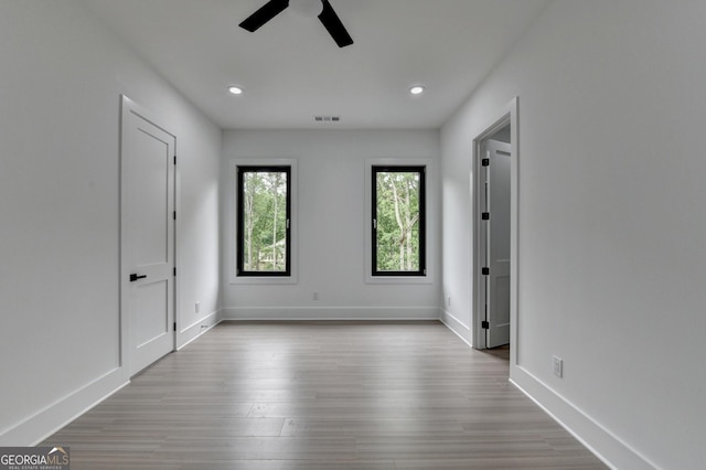 unfurnished bedroom with baseboards, recessed lighting, visible vents, and wood finished floors