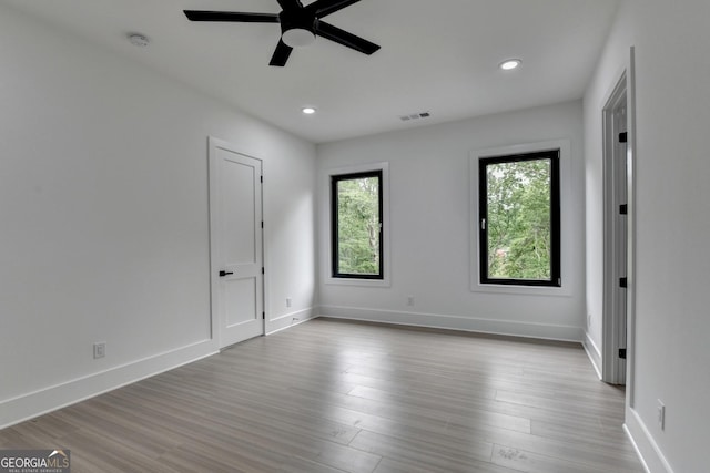 unfurnished bedroom with baseboards, visible vents, and wood finished floors