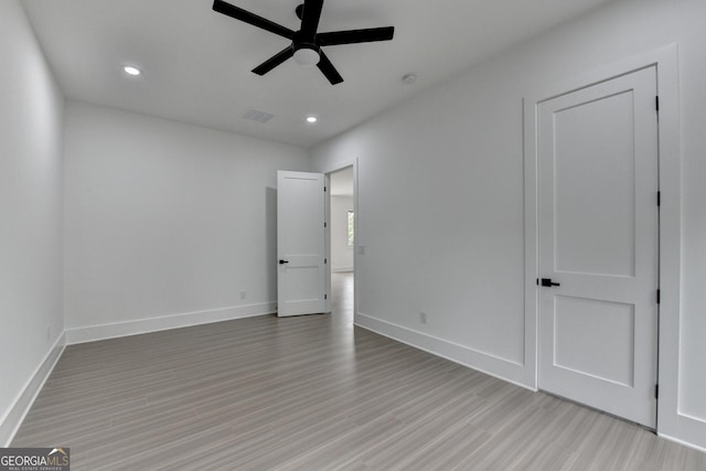unfurnished bedroom featuring recessed lighting, light wood-style flooring, and visible vents