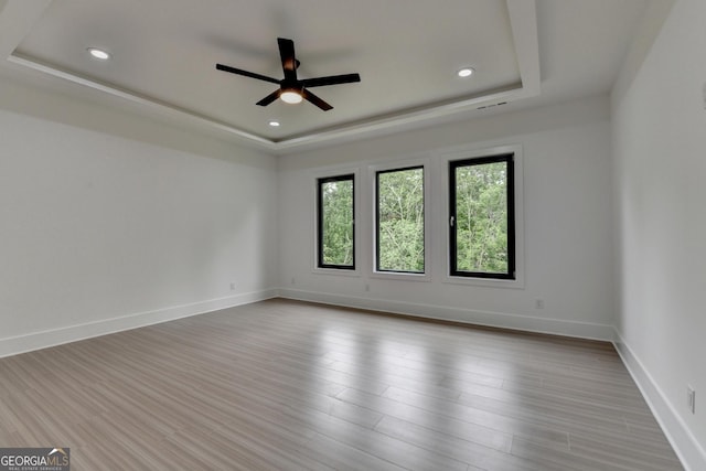 spare room featuring a ceiling fan, a raised ceiling, and recessed lighting