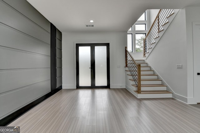 entrance foyer featuring recessed lighting, baseboards, visible vents, stairs, and wood finished floors