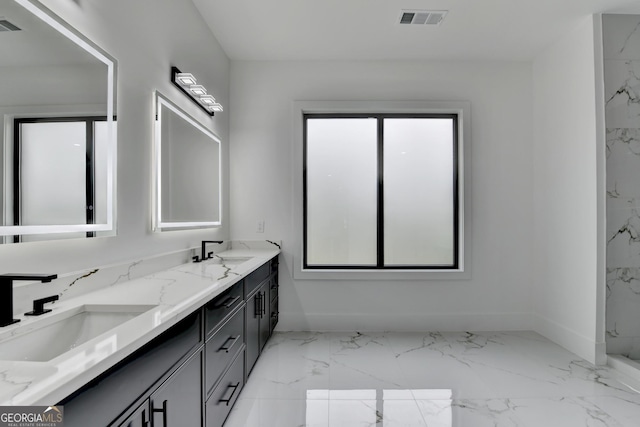 bathroom featuring baseboards, marble finish floor, visible vents, and a sink