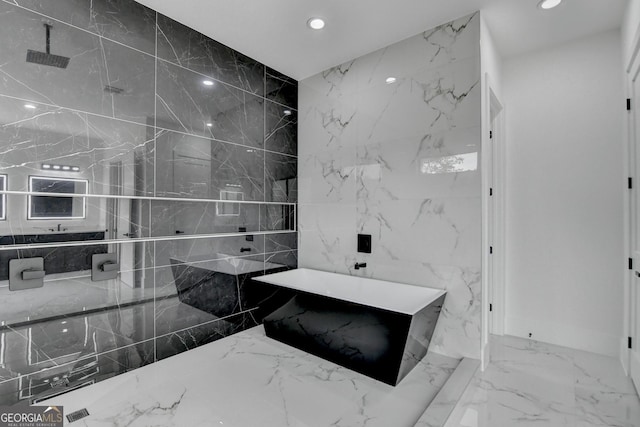 bathroom with marble finish floor, a freestanding bath, a shower, and recessed lighting