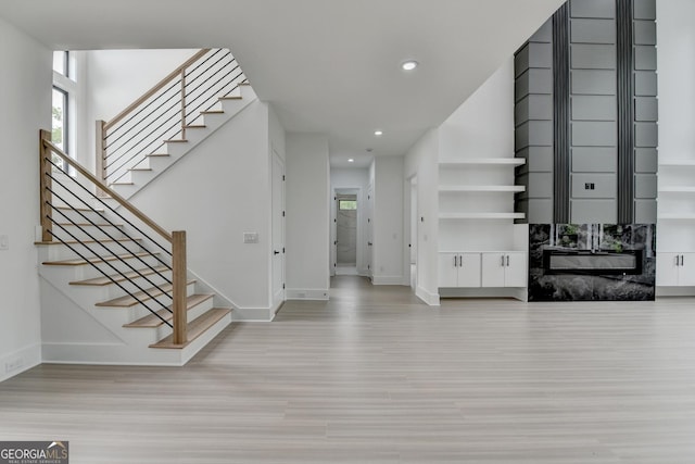 entrance foyer with stairway, recessed lighting, baseboards, and wood finished floors