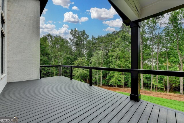 wooden terrace with a view of trees