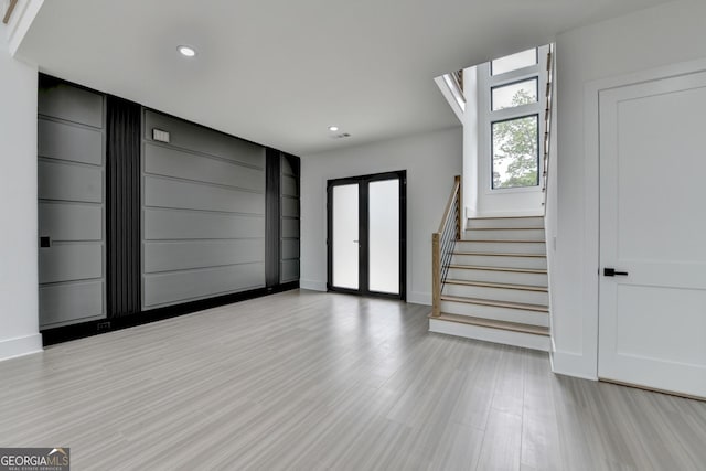 entrance foyer featuring baseboards, stairway, light wood-style flooring, and recessed lighting