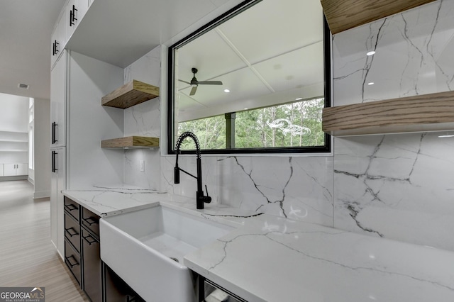 interior space with vanity, a ceiling fan, and backsplash