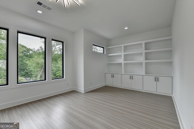 spare room with light wood-type flooring, visible vents, baseboards, and recessed lighting
