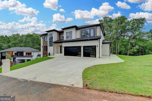 contemporary house featuring driveway, a standing seam roof, metal roof, an attached garage, and a front lawn