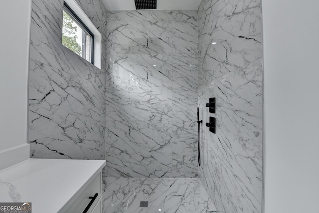 bathroom with a marble finish shower and visible vents
