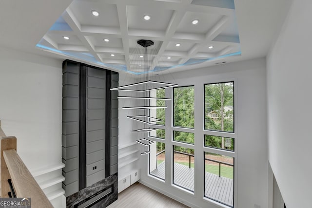 doorway with coffered ceiling, beamed ceiling, and recessed lighting