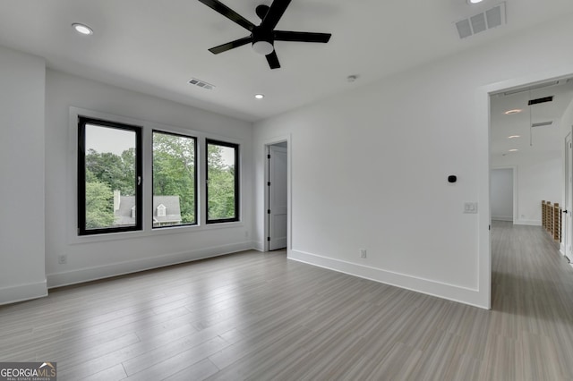 unfurnished room featuring visible vents, baseboards, and ceiling fan