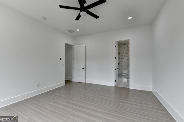 unfurnished bedroom with ensuite bath, visible vents, recessed lighting, light wood finished floors, and baseboards