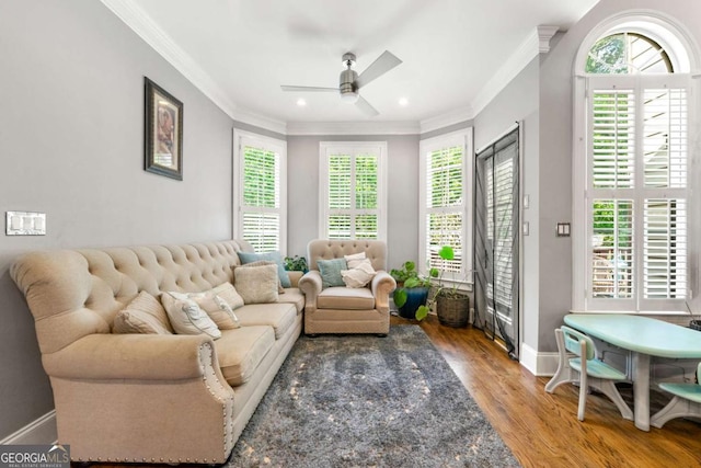 living room featuring a ceiling fan, recessed lighting, baseboards, ornamental molding, and wood finished floors