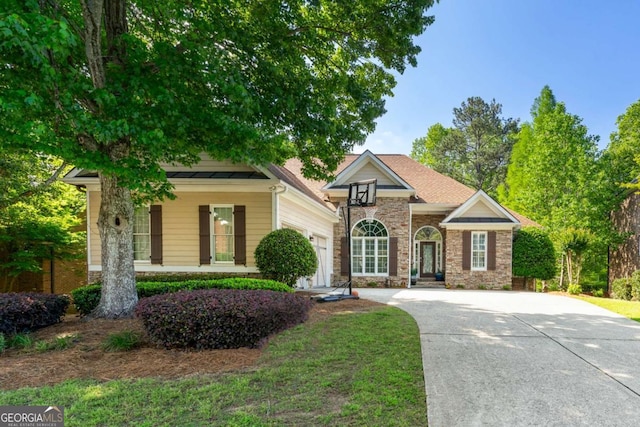 view of front facade featuring concrete driveway, a garage, and stone siding