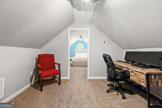 carpeted office featuring baseboards, visible vents, and vaulted ceiling