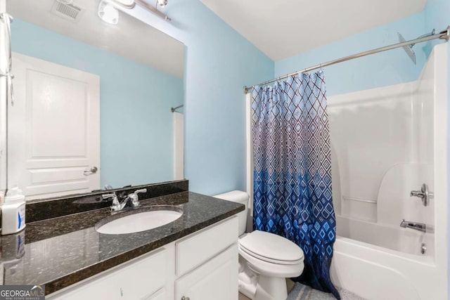 bathroom with vanity, toilet, shower / tub combo, and visible vents