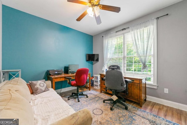 office area featuring baseboards, a ceiling fan, and wood finished floors