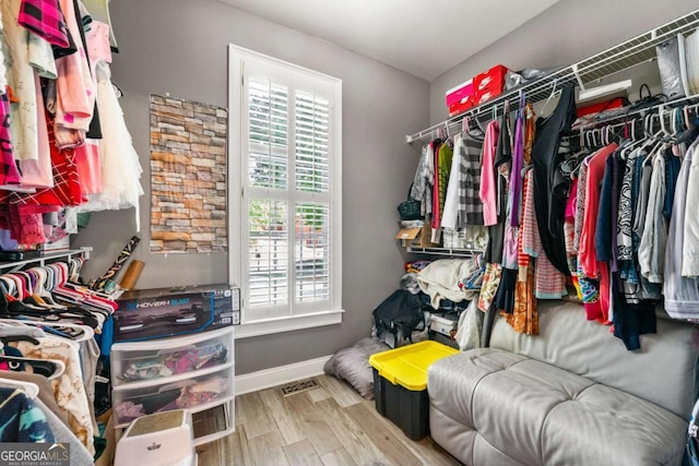 walk in closet with visible vents and wood finished floors