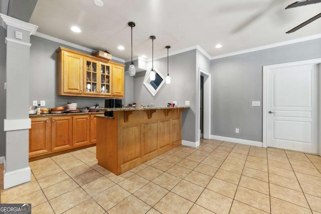 kitchen featuring glass insert cabinets, dark stone countertops, a kitchen breakfast bar, crown molding, and recessed lighting
