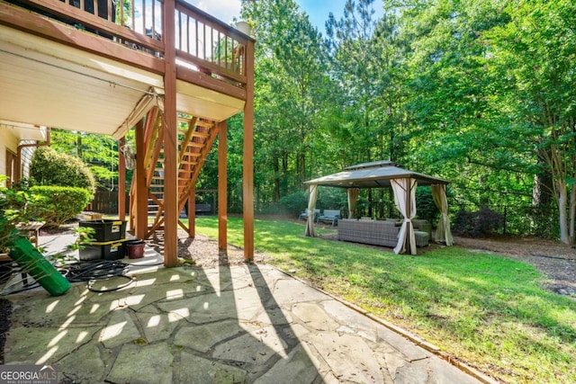view of patio / terrace with a gazebo, stairs, fence, a wooden deck, and outdoor lounge area