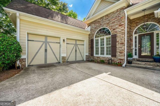 garage with concrete driveway