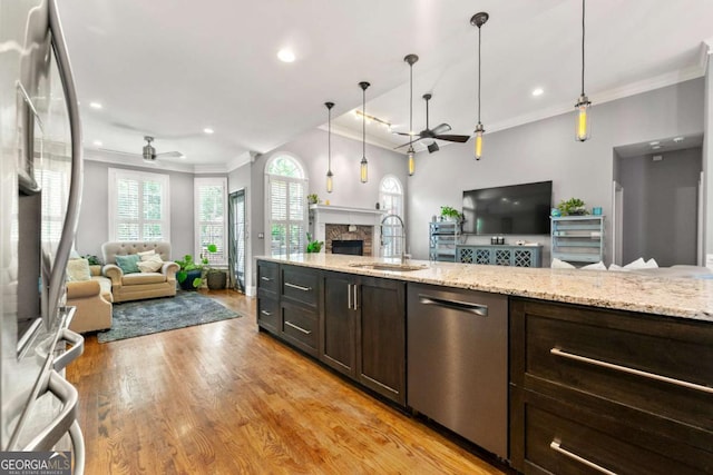 kitchen with a sink, ceiling fan, and open floor plan