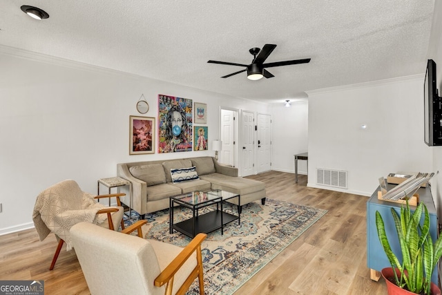 1750 Clairmont Rd Unit 32, Decatur, GA 30033 - living room featuring crown molding, a textured ceiling, ceiling fan, and wood finished floors