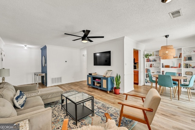 1750 Clairmont Rd Unit 32, Decatur, GA 30033 - living area with light wood-type flooring, a ceiling fan, crown molding, and a textured ceiling