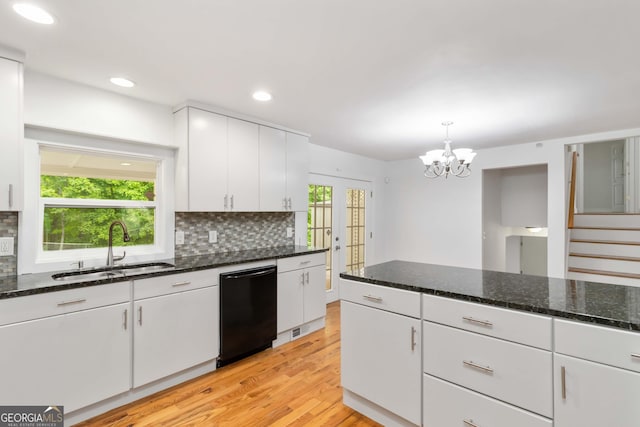 3781 Cherokee Trl, Suwanee, GA 30024 - kitchen featuring dishwasher, light wood-style flooring, decorative backsplash, white cabinets, and a chandelier