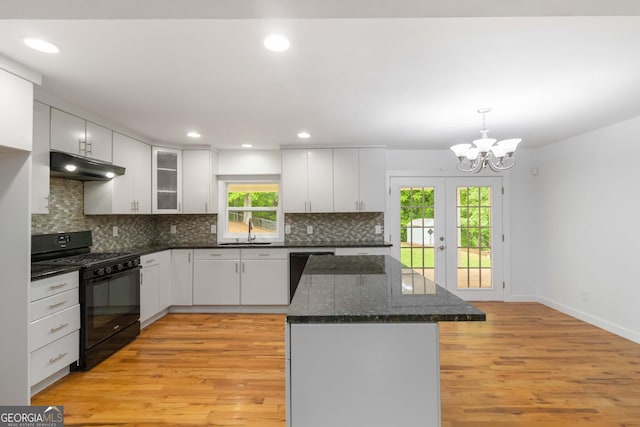 3781 Cherokee Trl, Suwanee, GA 30024 - kitchen with black appliances, under cabinet range hood, light wood-style floors, backsplash, and white cabinetry