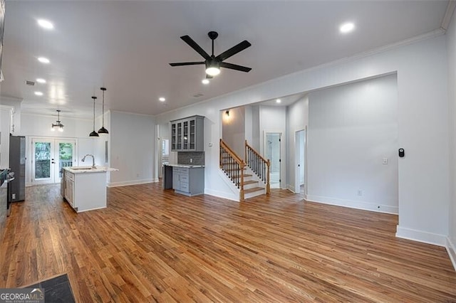 1120 Arlington Ave SW, Atlanta, GA 30310 - unfurnished living room with wood finished floors, a sink, crown molding, baseboards, and ceiling fan