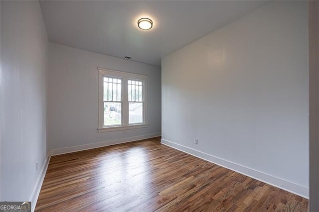 1120 Arlington Ave SW, Atlanta, GA 30310 - empty room featuring visible vents, baseboards, and dark wood-style floors