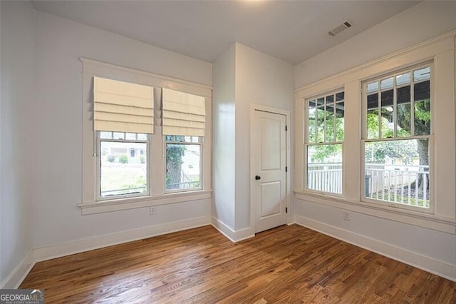 1120 Arlington Ave SW, Atlanta, GA 30310 - spare room with baseboards, a wealth of natural light, visible vents, and wood finished floors