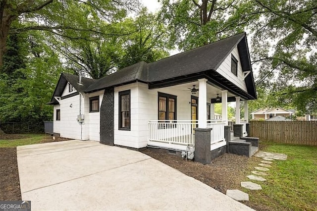 1120 Arlington Ave SW, Atlanta, GA 30310 - view of front of home with covered porch, fence, a front lawn, a ceiling fan, and a shingled roof