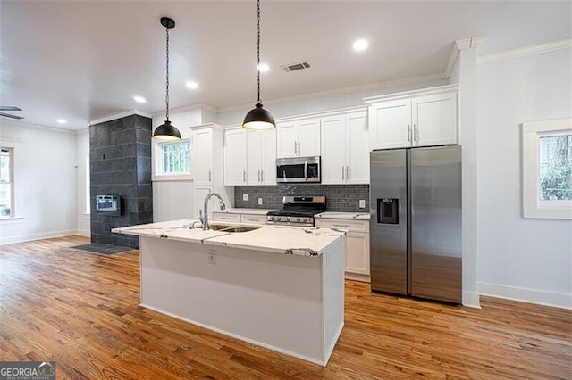 1120 Arlington Ave SW, Atlanta, GA 30310 - kitchen featuring a sink, stainless steel appliances, ornamental molding, visible vents, and baseboards
