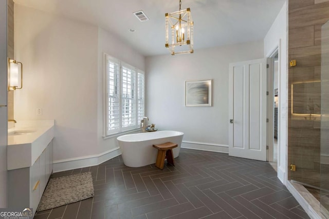 316 S Esplanade, Alpharetta, GA 30009 - full bath with a soaking tub, baseboards, visible vents, and a chandelier