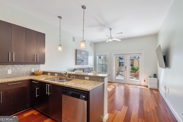kitchen with dishwasher, wood finished floors, open floor plan, and a sink