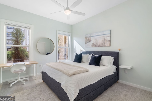 bedroom with multiple windows, baseboards, and carpet