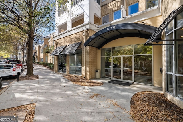 property entrance featuring brick siding