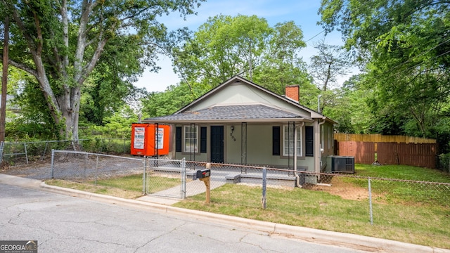 bungalow featuring covered porch, a gate, a chimney, central AC unit, and a fenced front yard